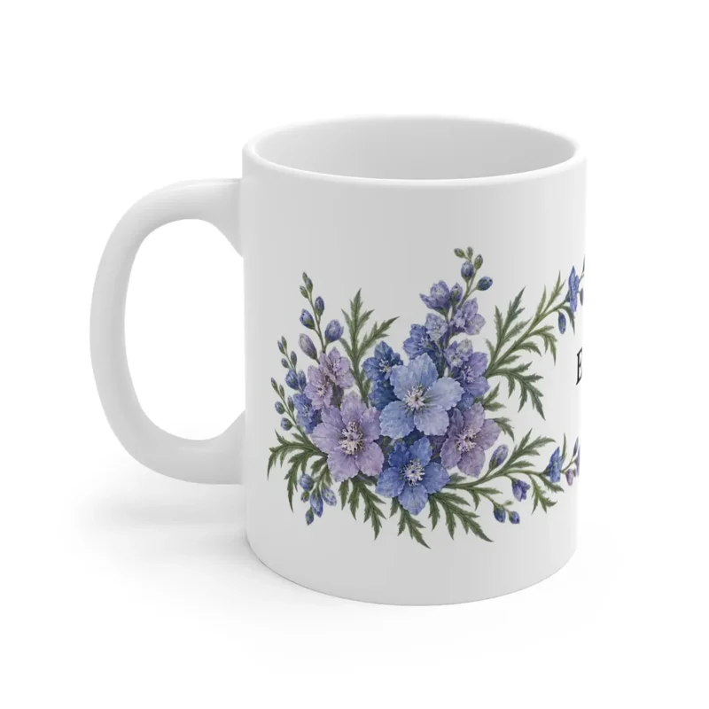 July larkspur wrap on a white ceramic mug, floral-facing view — digital mockup