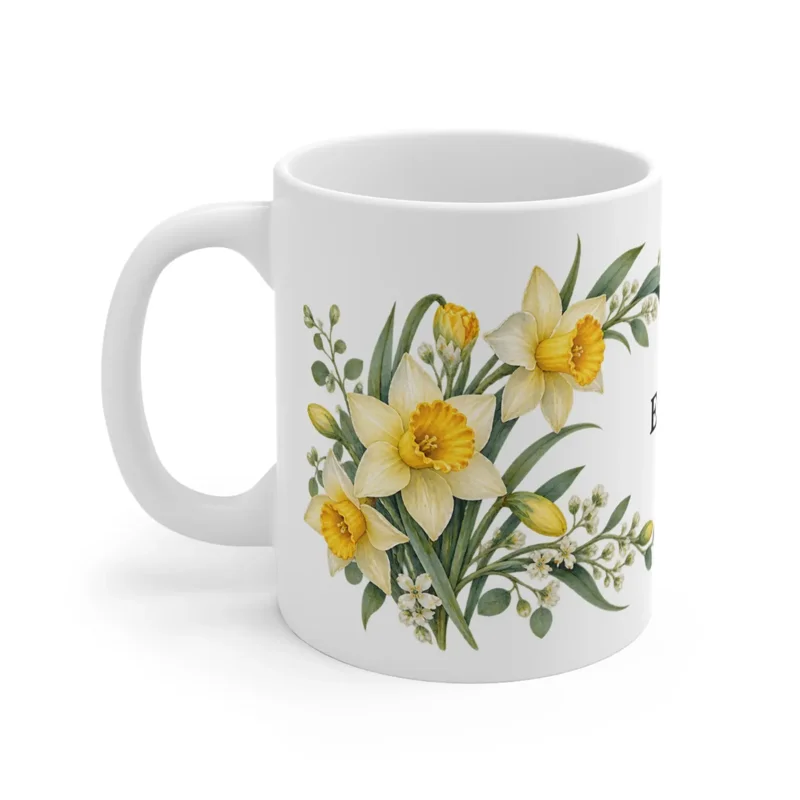 March daffodil wrap on a white ceramic mug, floral-facing view — digital mockup